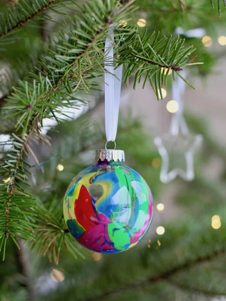 Colorful kids round ball tree ornament on christmas tree