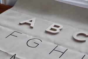 DIY wood letters on alphabet gathre mat