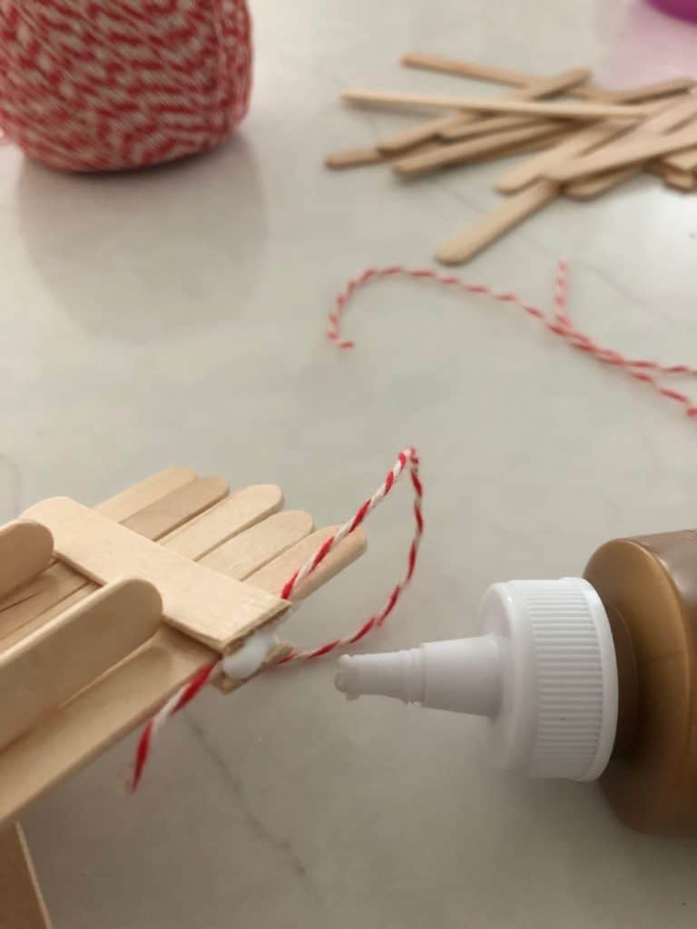 Glue on string for hanging up sled ornament