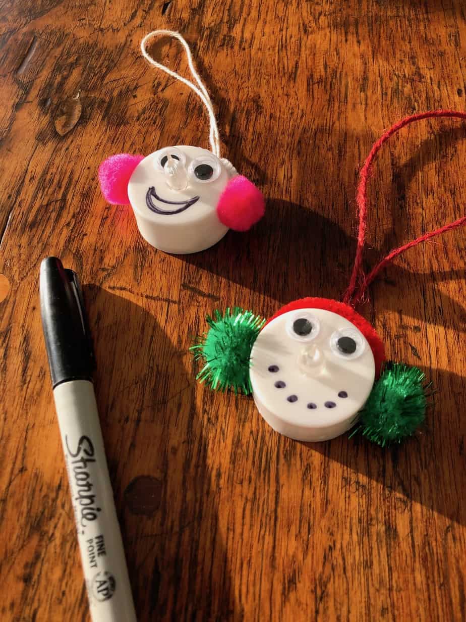 Drawing mouths on snowmen ornaments
