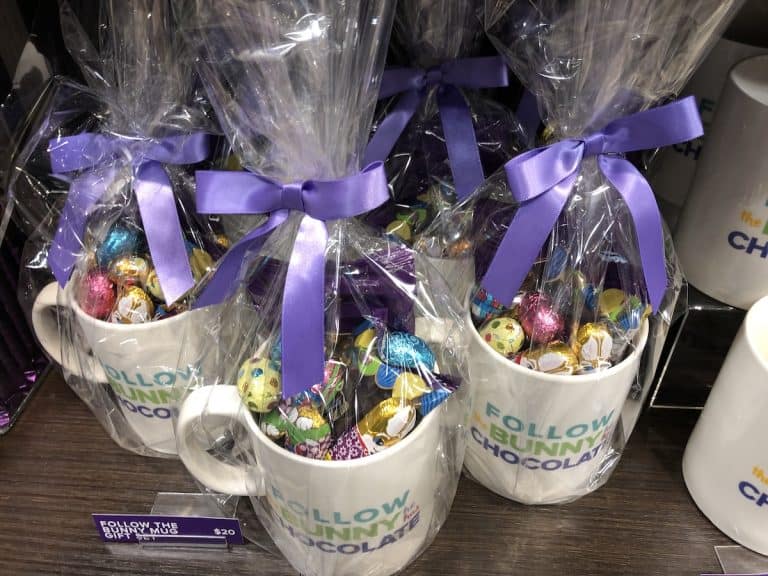 Hot chocolate gift basket in ceramic mug with cellophane and purple ribbon bow