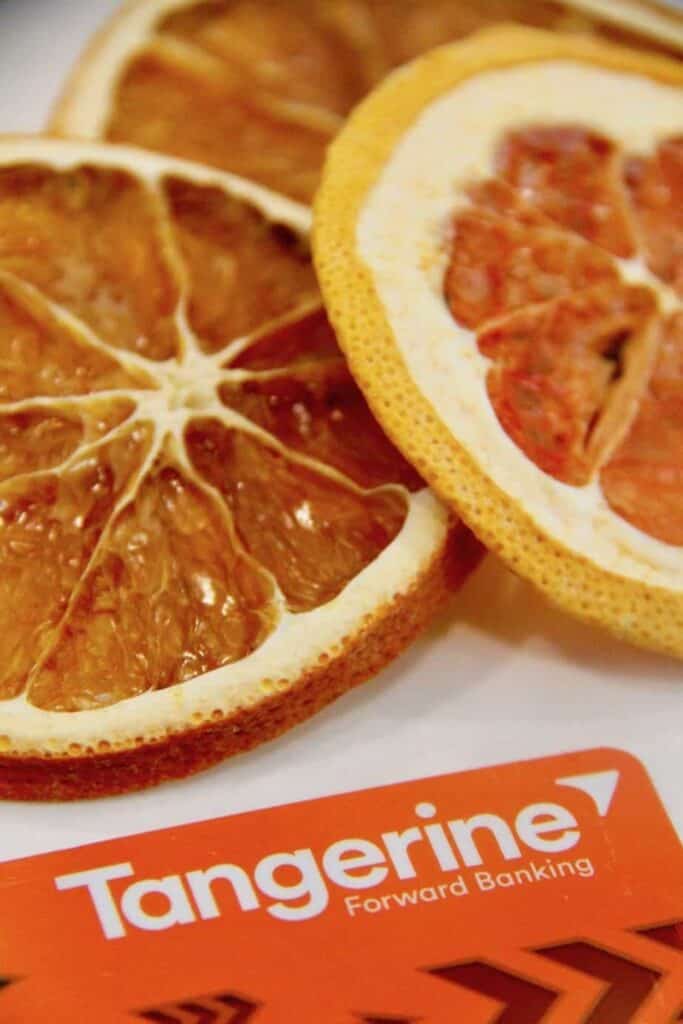 Shopping tips: tangerine forward banking card pictured with two slices of orange.