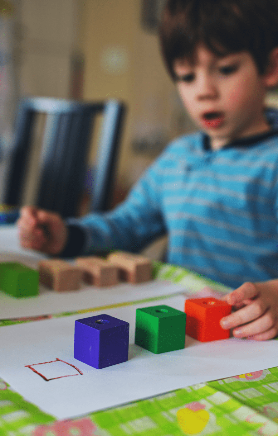 Child sorting blocks by shape