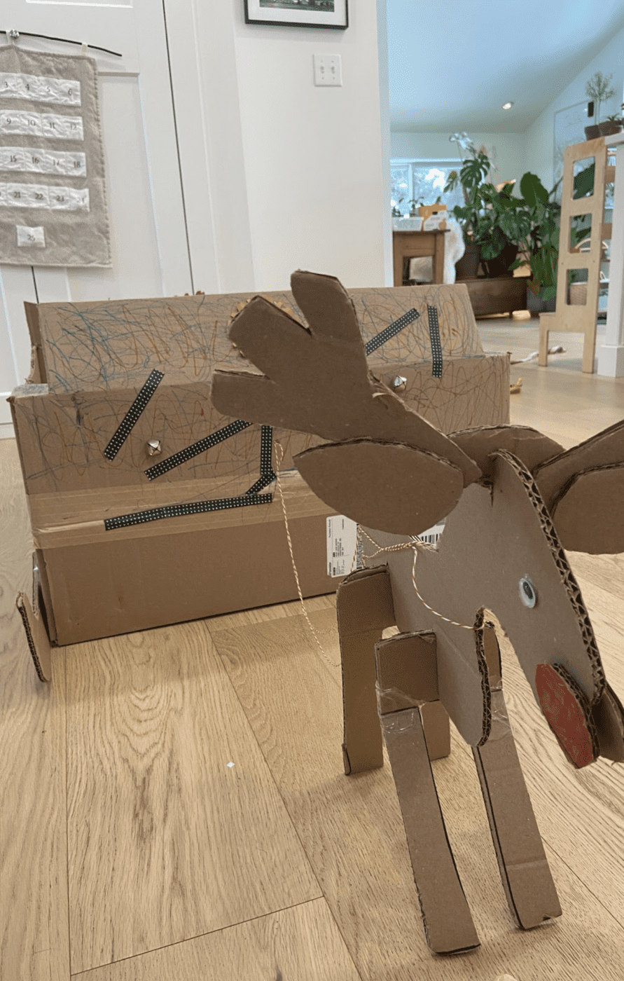 A reindeer and sleigh made out of cardboard boxes.