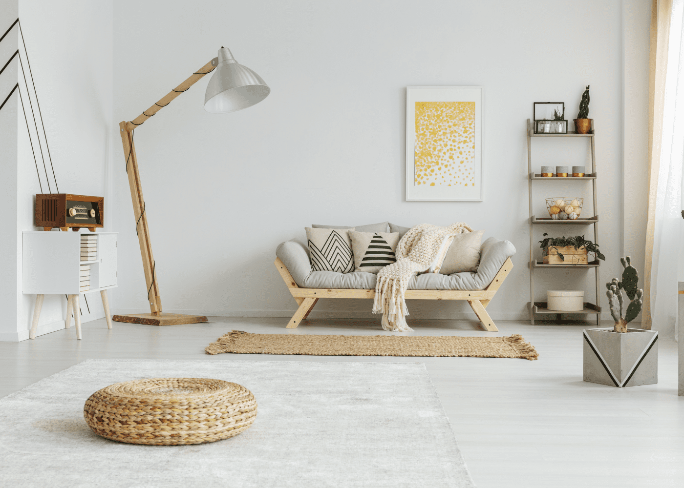 How to flatten a rug? A photo of a living room decorated in neutral colors with a rattan rug.