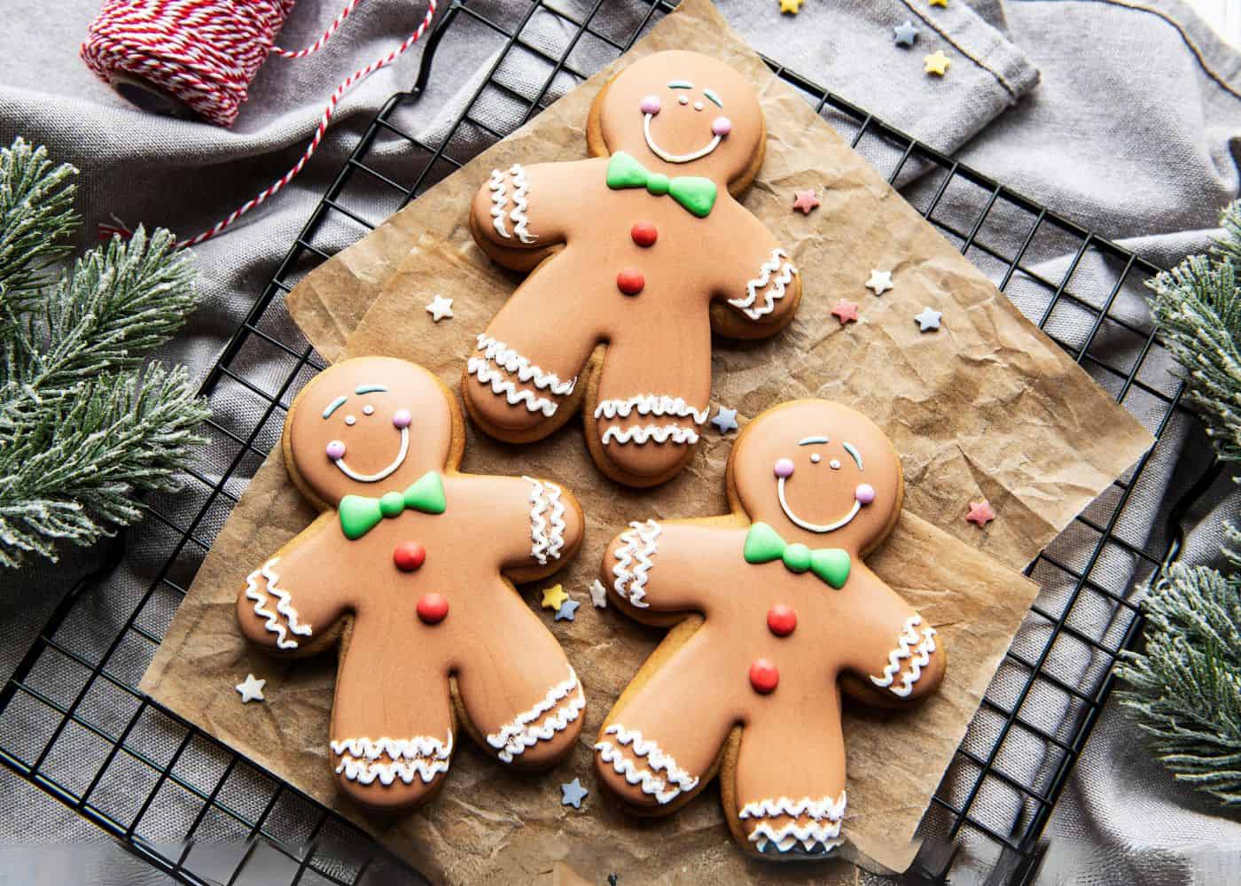 Freshly decorated gingerbread men on a baking rack